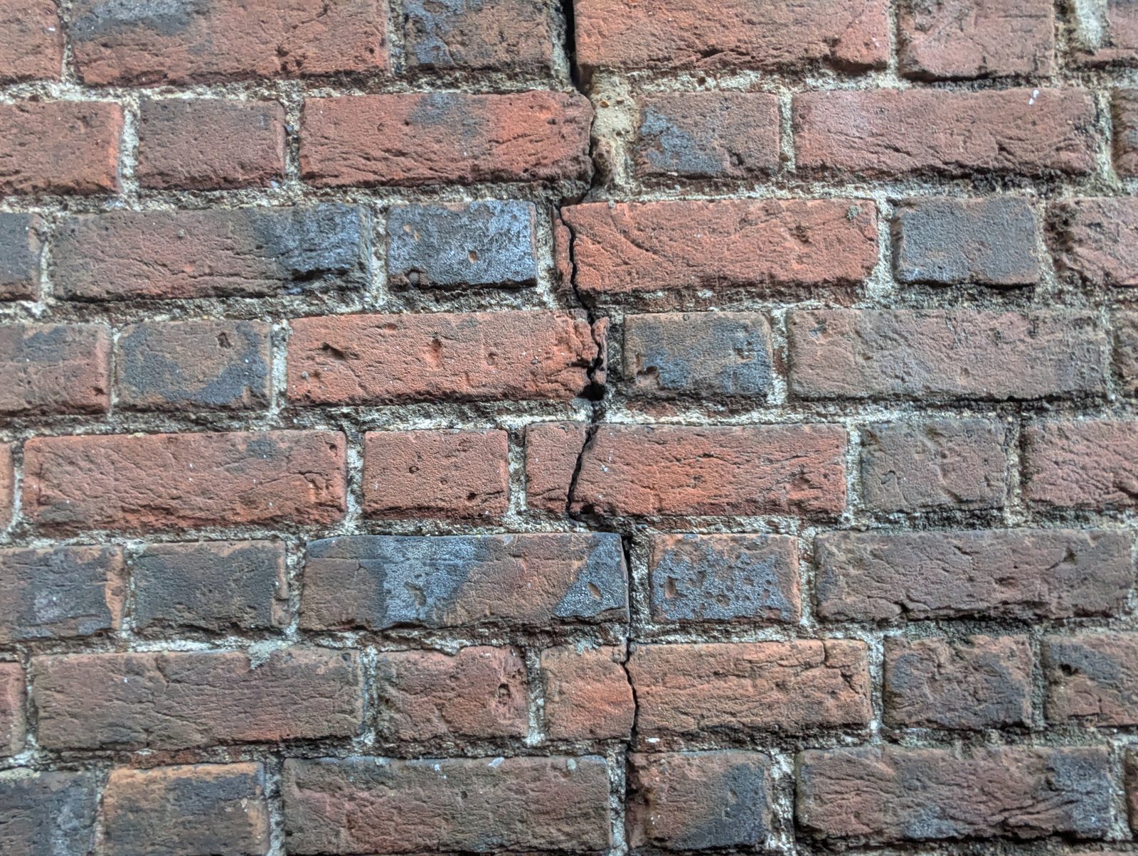 Diagonal cracking around a window opening, a sign of structural movement